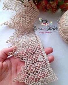 someone is showing off their hand made lace