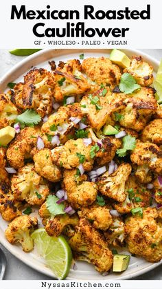 mexican roasted cauliflower with cilantro, onions and lime on a white plate