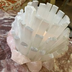 a white vase sitting on top of a marble table