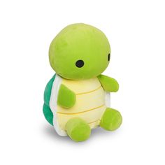 a small stuffed turtle sitting on top of a white surface