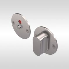 an image of two metal knobs on a white background and one has a red button