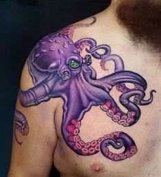 an octopus tattoo is on the chest of a man with green eyes and purple tentacles