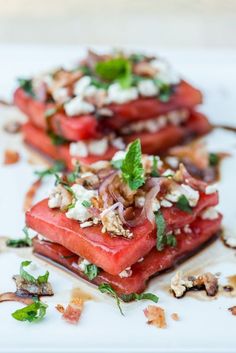 watermelon and feta salad on a white plate with mint garnish