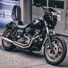 a black and gold motorcycle parked in front of a building