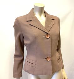 "1950s nipped jacket 36\" bust 28\" waist in a soft mocha. A neat little jacket that will look good with a dress or jeans. Nipped waist, it fastens with two large buttons. Nice use of the fabric as trim along the collar edges and split pocket detail. Fully lined, in beautiful condition, Label: Peter Robinson Measurements taken laid flat and across, please double for actual size. Please note the measurements are for the actual garment Shoulder span 15\" Bust 19\" Waist 15\" Underarm seam 16.1/2\" Peter Robinson, Blue Embroidered Top, Large Buttons, Hollywood Glamour, Embroidered Top, Pocket Detail, Vintage Tops, Womens Clothing Tops, Mocha