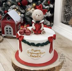 a christmas cake with a teddy bear on top