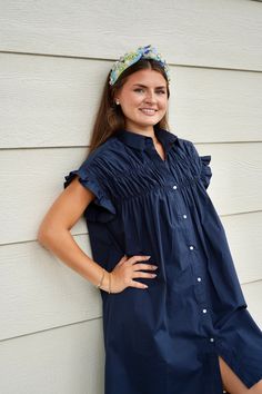 This Gathered Shirt Dress in Navy is all about playful, flirty style. The pointed collar and front button closure elevate the classic shirt dress silhouette. Elasticated ruffled armholes add a touch of whimsy, while the bust gathers create a flattering fit. Perfect for a fun day out (and maybe a twirl or two)! Length : 91cm for Size Small