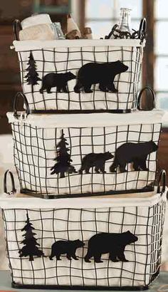 three baskets with bear silhouettes are stacked on top of each other in front of a fireplace