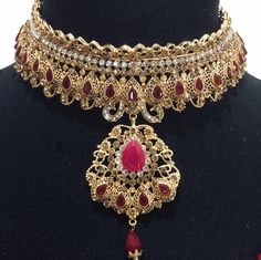 Chandbali Jewelry With Elegant Design For Wedding, Red Chandbali Bridal Necklace For Wedding, Elegant Chandbali Jewelry For Wedding, Elegant Chandbali Wedding Jewelry, Elegant Red Kundan Necklace For Wedding, Bollywood Style Hand Set Bridal Necklace, Bollywood Style Bridal Sets With Intricate Design, Gold Ruby Jewelry Sets For Wedding, Bollywood Bridal Sets With Intricate Design For Wedding