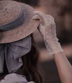 a woman with a hat and gloves on