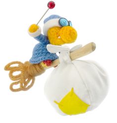 a knitted bird is holding on to a white bag with a wooden stick in it