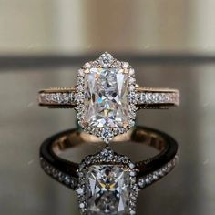 an engagement ring with a cushion cut diamond surrounded by pave diamonds