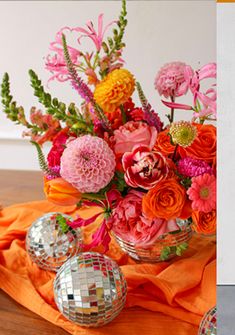 two pictures with flowers and disco balls on the table next to each other in vases