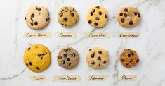 nine different types of chocolate chip cookies on a white marble counter top with name tags