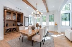 a large dining room table with white chairs