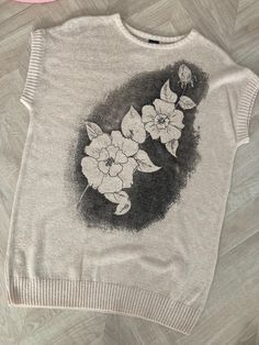 a sweater with flowers drawn on it