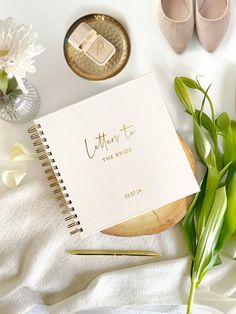 a notepad with the words, letters to the bride on it next to some flowers and a pair of shoes