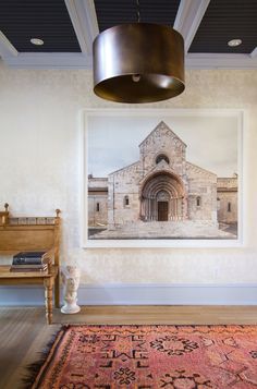 a painting hanging on the wall next to a wooden bench