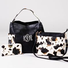 In love with adorable and summer fun cow print? We picked this set of bags just for you! The 'Wildest Dreams Cow Print Handbag' features two large exterior pockets, 11.5"h x 16"w, snap closure. The 'Wildest Dreams Crossbody Bag' measures 9"h x 10.5"w features an adjustable strap and interior pockets. The 'Wildest Dreams Cow Print Wallet' is only our most fierce wallet yet! When you pull this baby out of your bag, people will know you mean business! It measures 4"h x 8.5"w and features a zipper p Rectangular Cow Print Travel Bag, Trendy Cow Print Bags For Everyday Use, Black Bag With Cow Print For Everyday Use, Casual Everyday Bag With Cow Print, Casual Cow Print Bags For Daily Use, Embroidered Monogram, Wildest Dreams, Printed Handbags, Leather Products