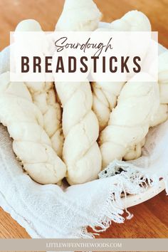 sourdough bread sticks in a white bowl on a wooden table with text overlay