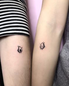 two people with matching tattoos on their arms