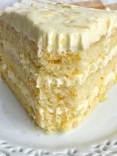 two pieces of cake sitting on top of a white plate covered in frosted icing