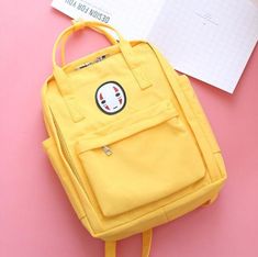 This cute backpack features an illustration of Japanese Kaonashi spirit. It has a spacious main compartment, two side pockets and one front zipper pocket. The bag has two top handles that can be joined with a stud closure. It is sure to be the best backpack for wherever your day takes you. Size:- Length: 10.2" (26cm)- Width: 4.7" (12cm)- Height: 13.4" (34cm) Material: polyester Yellow School Backpack With Pockets, Backpack Fabric, Kawaii Backpack, Cute Backpack, Kawaii Pens, Swedish Style, No Face, Cute Backpacks, Cool Backpacks