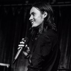 a black and white photo of a woman holding a microphone