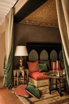 a living room filled with lots of furniture next to a wall covered in drapes