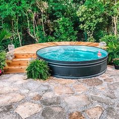 an outdoor hot tub surrounded by plants and trees