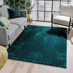 a living room filled with furniture and a green rug