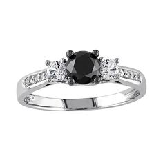 a black and white diamond ring with three stones on the band, set in 18k white gold