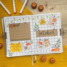 an open planner with the words october written on it, surrounded by fall decorations and pumpkins