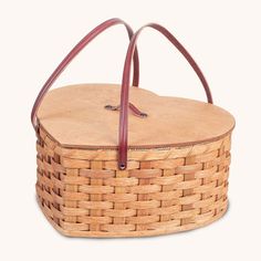 a woven basket with leather handles and straps