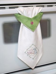 a white oven with a green tie hanging from it's side