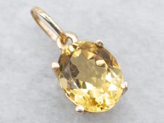 Make a statement with this show-stopping yellow gold solitaire pendant featuring a yellow beryl oval cut gem. Rock this unique piece and you'll be sure to stop traffic! Perfect for a night out on the town.This pendant does not come with the chain shown. Please feel free to contact us, we will help you find the perfect chain for your style and budget!Metal: 14K Yellow GoldGem: Yellow Beryl 2.58 CaratsGem Measurements: 7.8 x 9.7 mm, OvalMeasurements: 8 x 17 mm, with bailMarks: "MU 14K" Stamped on the bail Yellow Gold Solitaire, Pocket Watch Chain, Watch Chain, Solitaire Pendant, Pearl Pendant, Charm Earrings, Beaded Chain, 25 Years, Hampshire