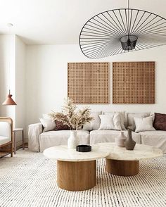 a living room with two couches and a coffee table in front of the wall