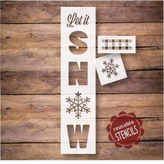 the words let it snow are cut out and placed on top of a wooden background