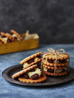 some cookies are stacked on a plate and tied with twine