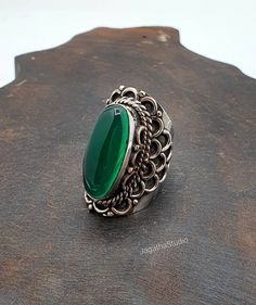 HANDMADE  Green Onyx stunning Bohemian statement ring with beautiful detail at the sides of the piece. A very special statement piece, a pure Bohemian spirit. The symbol of restfulness and purity. This green soothing stone has the power to relief you all worries, tension, stress and fears. It's believed to provide a positive feeling, strong mental support and helps to take wise decisions during your difficulties. SIZE Ring size: 9 1/4 US Aprox Height: 3.7 cm  Aprox Width: 2.1 cm Handmade with hi Bohemian Oval Rings With Stone Setting, Bohemian Oval Stone Setting Rings, Bohemian Oval Rings With Intricate Design, Handmade Elegant Oval Cabochon Crystal Ring, Elegant Handmade Oval Cabochon Crystal Ring, Mental Support, Bohemian Ring, Big Rings, Feeling Positive