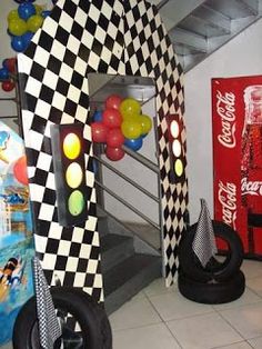 a room filled with lots of toys and balloons on the floor in front of a coca - cola machine