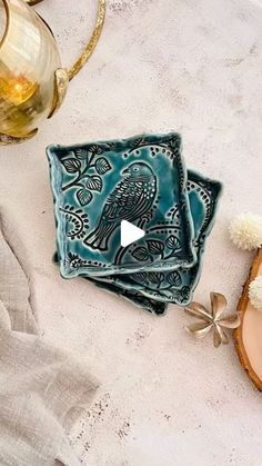 two blue plates sitting on top of a table next to a cup and saucer