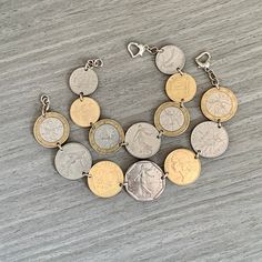 "Vintage French Coin Bracelet, Coin Jewelry,  France Souvenir, Silver Jewelry, Marianne Coin, Wanderlust, Statement Jewelry ---------------------------------------------------------------- Coin:  1 Franc, 2 Franc, 10 Franc, and 20 Centimes  Country: France Years: Various Have you traveled to France recently?  Celebrating your French heritage?  This bracelet made from pre-Euro French coins would make any lady a wonderful gift! Smaller sizes will be made with different denomination coins but similar design (see photo).  Also available as a charm bracelet if you prefer the coins to dangle from a chain rather than be linked together. These are authentic circulated coins prior to the Euro that have their own natural patina and markings. Looking for more French coin jewelry?  Check out my other Metal Coin Bracelets For Gift, Metal Coin Bracelets As Gifts, Nickel-free Coin-shaped Bracelets As Gifts, Penny Jewelry, Gold Coin Jewelry, French Heritage, Coin Jewellery, French Coins, Country France