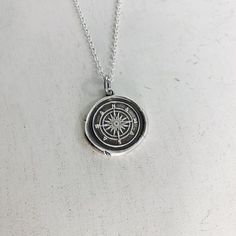 Do you love to travel? This handmade silver charm is perfect for those who love adventure!The pendant measures approximately 3/4" and is made from .999 fine (pure) silver.  Each pendant is handmade by me in a multiple step process until it becomes a pendant that resembles the old fashioned wax seals found on vintage envelopes.  Every pendant will be unique and have its very own "personality".  I believe in perfect imperfections, so the way it comes out of the batch is how it is meant to be.  I a Personalized Silver Necklace For Souvenir, Nickel Free Sterling Silver Amulet Charm Necklaces, Nickel-free Sterling Silver Amulet Charm Necklace, Silver Sterling Amulet Charm Necklace, Sterling Silver Amulet Charm Necklace, Silver Sterling Silver Amulet Charm Necklace, Spiritual Silver Jewelry Souvenir, Everyday Sterling Silver Charm Necklace With Medallion, Sterling Silver Compass Necklace For Travel