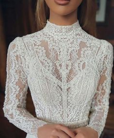 an image of a woman wearing a white dress with lace on the neck and sleeves