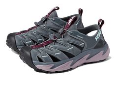 Hoka Hopara - Women's Shoes : Castlerock/Elderberry : For information on how HOKA ONE ONE contributes to the community, please visit the page. The Hoka One One Hopara trail and hiking sandals will quickly become a favorite for the true outdoor explorer! Surface : Hiking / Mountain / Trail. Heel-Toe Drop : 5.00mm. Stability : Neutral; allows the foot to adopt its natural placement. Cushioning : Responsive; provides enhanced response, durability, cushioning, and energy return. Synthetic and neopre Hiking Sandals With Vibram Sole, Breathable Closed Toe Sport Sandals For Walking, Waterproof Sport Sandals For Walking, Functional Waterproof Sport Sandals For Outdoor Activities, Waterproof Functional Sport Sandals For Walking, Waterproof Functional Sport Sandals For Outdoor Activities, Breathable Functional Sport Sandals For Walking, Functional Waterproof Walking Sport Sandals, Waterproof Functional Hiking Sandals