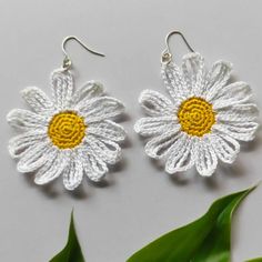 two white and yellow crocheted flower earrings