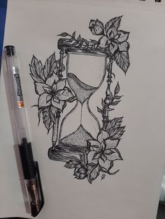 a drawing of an hourglass with flowers and leaves on it next to a marker pen