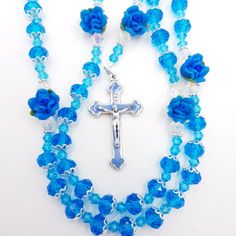 Handmade Crystal Rosary in blue. Makes a great gift for baptisms, first communions, birthdays. Appropriate for both baby boy or girl. If you would like to change the centrepiece, please just ask (Communion Chalice, Confirmation Dove, Mary & Baby-Baptism, Miraculous Medal). Use at mass or daily prayer to deepen your prayer life. Give this as a gift or use it as you meditate on the mysteries of the Holy Rosary. These pieces are hand crafted to help promote the Rosary and encourage you with your de Blue Spiritual Jewelry For First Communion, Blue Cross Rosary As Gift, Handmade Blue Rosary With Cross, Blue Cross Rosary For Gift, Handmade Blue Rosary With Cross Shape, Flower Rosary, Boy Or Girl Baby, Praying The Rosary, Holy Rosary