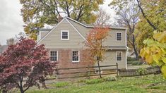 a house in the fall with autumn leaves